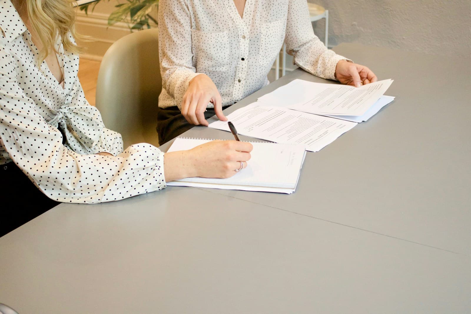 Two people going through paperwork at a table